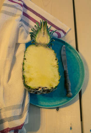 Fresh ananas fruit on vintage style plate. Toned imageの写真素材