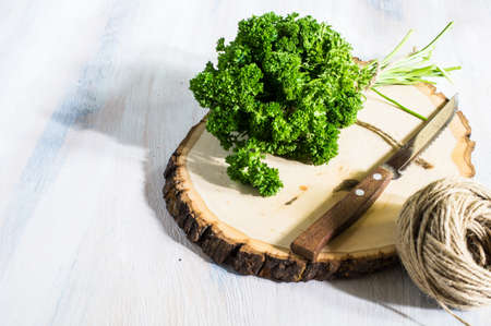 Fresh parsley herb as a cooking concept on the old wooden table