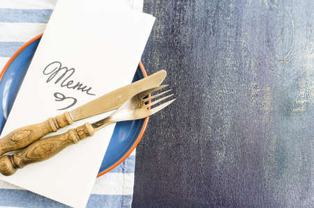 Rustic table setting with vintage plates and silverwareの写真素材