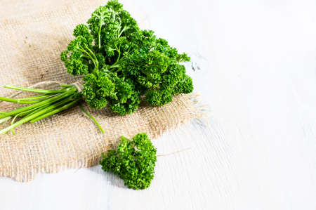Fresh parsley herb as a cooking concept on the old wooden tableの写真素材