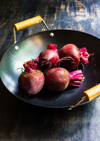 Fresh organic beet vegetable on vintage plate on rustic wooden background
