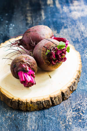 Fresh organic beet vegetable on vintage plate on rustic wooden background