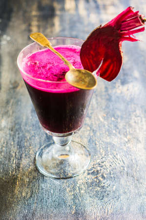 Detox smoothie drink of organic beet vegetable on rustic wooden table