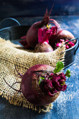 Fresh organic beet vegetable on vintage plate on rustic wooden background