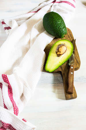 Fresh avocado vegetable on vintage style plate on rustic wooden table