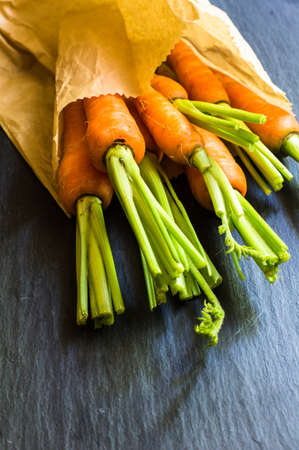 Ripe fresh organic carrots on rustic wooden backgroundの写真素材