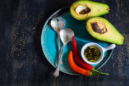 Fresh ingredients for cooking on dark wooden background.