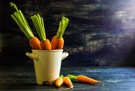 Ripe fresh organic carrots on rustic wooden backgroundの写真素材