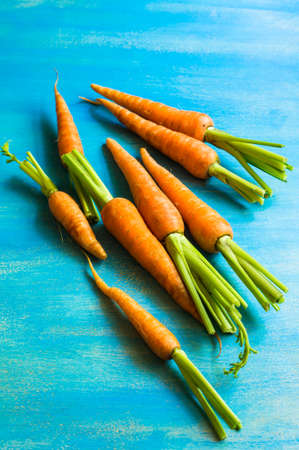 Ripe fresh organic carrots on rustic wooden backgroundの写真素材