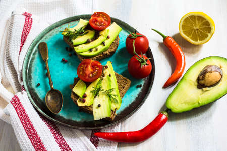Bruschetta with tomato, avocado, chilli peper and herbs