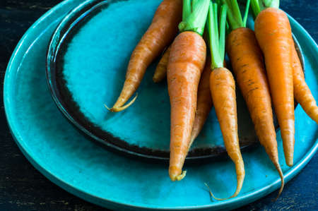 Ripe fresh organic carrots on rustic wooden backgroundの写真素材