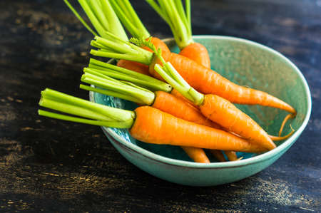 Ripe fresh organic carrots on rustic wooden backgroundの写真素材