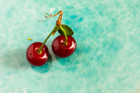 Fresh cherry berries on rustic wooden table and vintage backgroundの写真素材