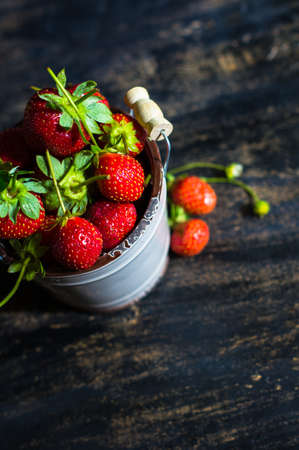 fresh strawberry fruits as a summertime dessert on rustic wooden tableの写真素材