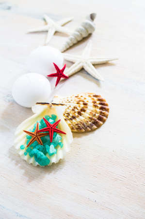 Spa concept with sea stars, sea salt and towels on rustic backgroundの写真素材