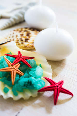 Spa concept with sea stars, sea salt and towels on rustic backgroundの写真素材