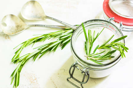 Cooking concept with fresh rosemary and spices on rustic backgroundの写真素材