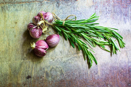 Cooking concept with fresh rosemary and spices on rustic backgroundの写真素材
