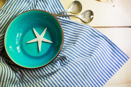 Rustic marine table setting with sea stars and vintage tableclothの写真素材