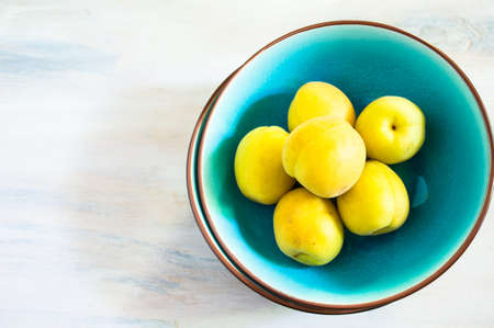 Fresh organic apricot fruits on rustic wooden tableの写真素材