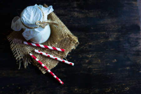 Vintage glass bottle with organic milk on rustic wooden tableの写真素材