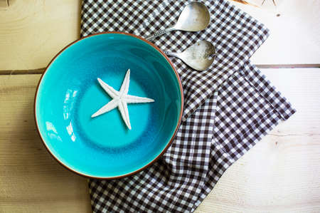 Rustic marine table setting with sea stars and vintage tableclothの写真素材
