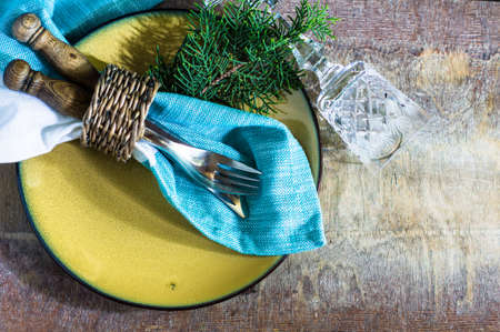 Rustic table setting with vintage silverware ad plates on old styled napkinsの写真素材