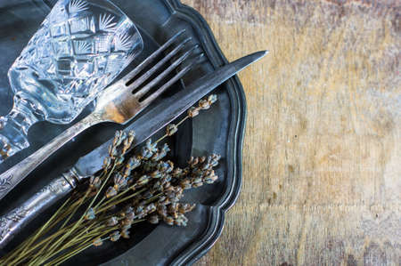 Rustic table setting with vintage silverware ad plates on old styled napkinsの写真素材