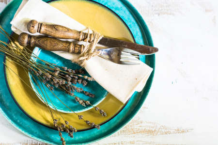Rustic table setting with vintage silverware ad plates on old styled napkinsの写真素材