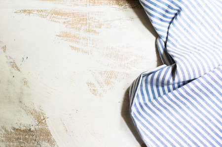 Kitchen towel or napkin over the rustic wooden table. View from above with copy spaceの写真素材