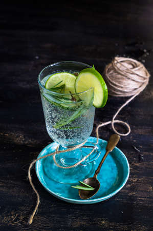 Detox beverage with fresh lime and rosemary on rustic backgroundの写真素材