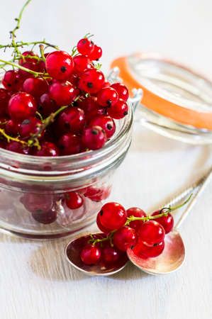 Red organic currant berries on old rustic wooden tableの写真素材