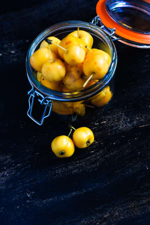 Autumnal concept with crab apples on rustic backgroundの写真素材