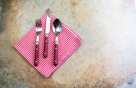 Rustic table setting with vintage silverware and plates on stone tableの写真素材