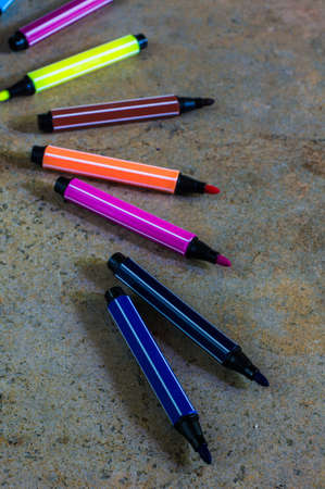 multicolored pensils on the wooden board