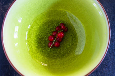 Red organic currant berries on old rustic wooden tableの写真素材