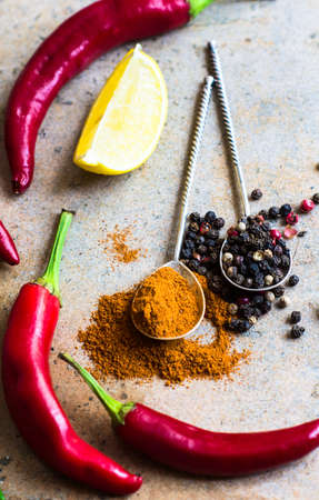 Different types of pepper spice on stone table