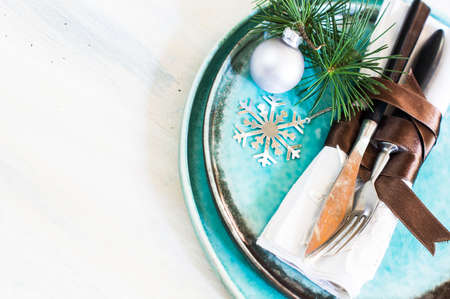 Christmas time table setting with vintage silverware on plate and napkinの写真素材