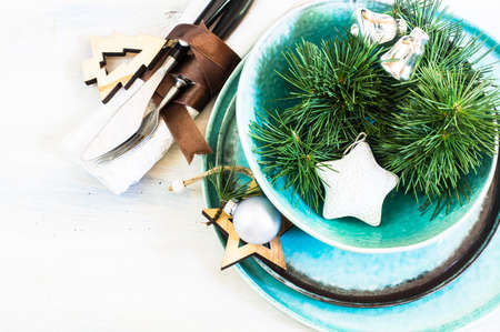 Christmas time table setting with vintage silverware on plate and napkinの写真素材
