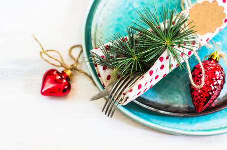 Christmas time table setting with vintage silverware on plate and napkin