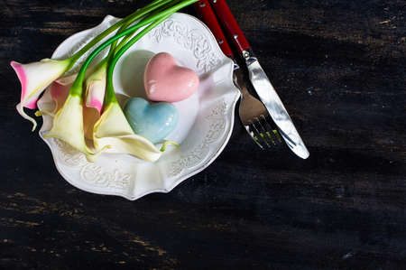 Table setting for St. Valentines day with herats on vintage wooden table