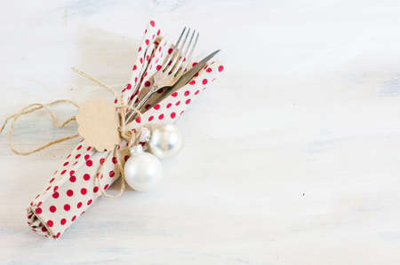 Christmas time table setting with vintage silverware on plate and napkinの写真素材