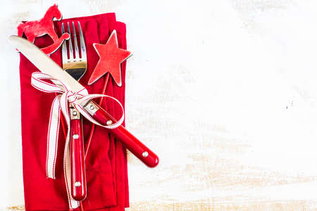 Christmas time table setting with vintage silverware on plate and napkinの写真素材