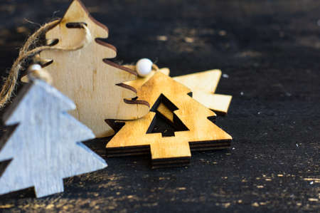 Wooden old-styled decorations for Christmas holidays on rustic background
