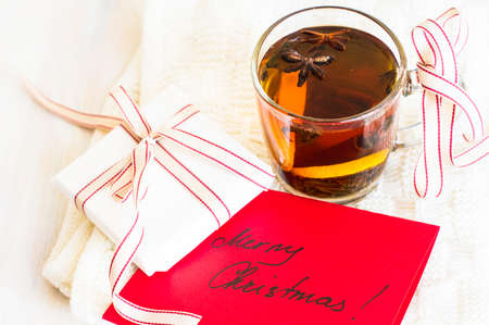 Christmas tine tea with lemon and spices like cinnamon sticks and anise star on rustic backgroundの写真素材