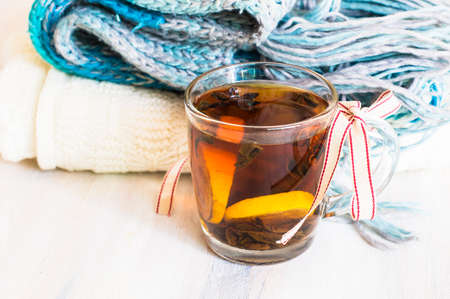 Christmas tine tea with lemon and spices like cinnamon sticks and anise star on rustic backgroundの写真素材