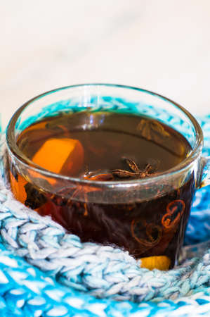 Christmas tine tea with lemon and spices like cinnamon sticks and anise star on rustic backgroundの写真素材