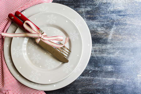 Christmas time table setting with vintage silverware on plate and napkinの写真素材