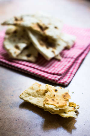 Italian focaccia bread with rosemary and garlic on rustic table