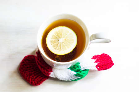 Cup of tea with lemon and chistmas time decor on rustic wooden tableの写真素材